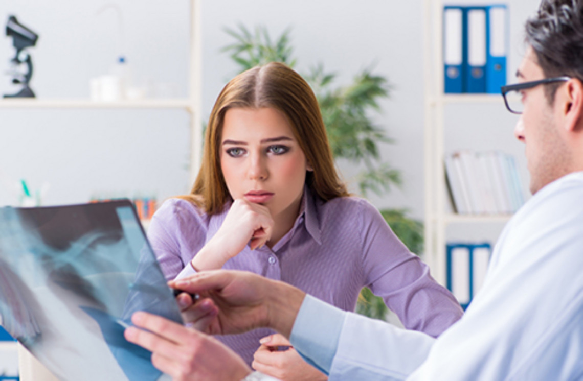 Healthcare professional showing a lung X-ray during a medical consultation