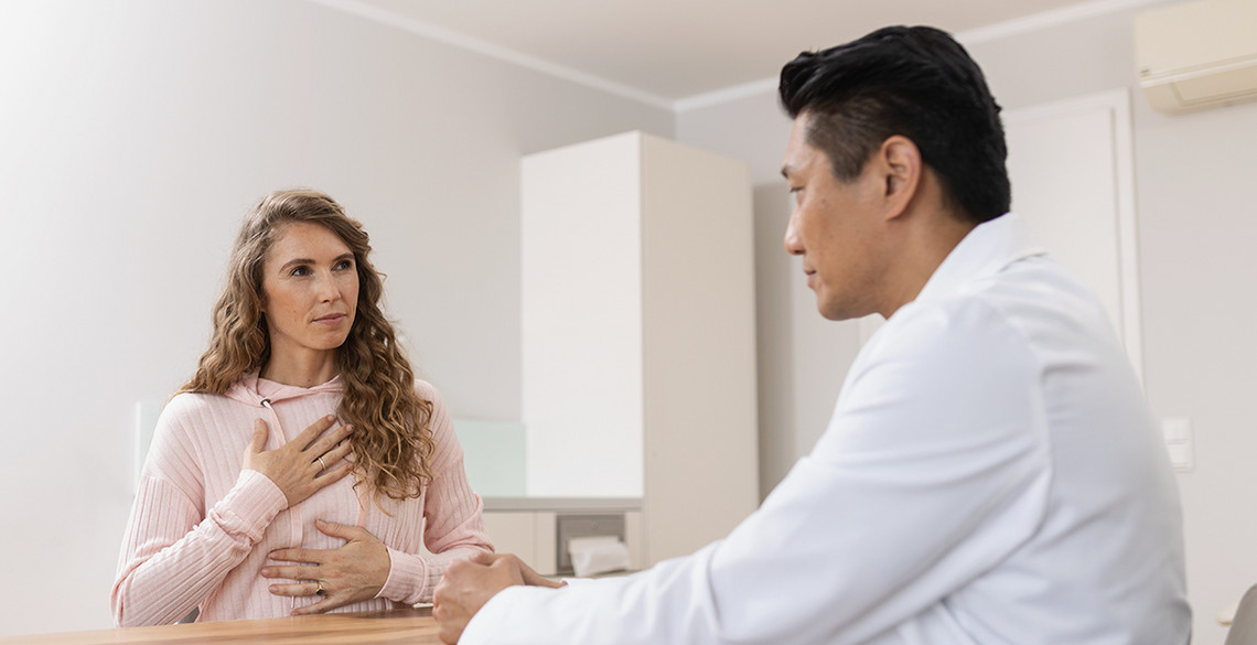 Further examination options Healthcare professional showing a lung X-ray during a medical consultation