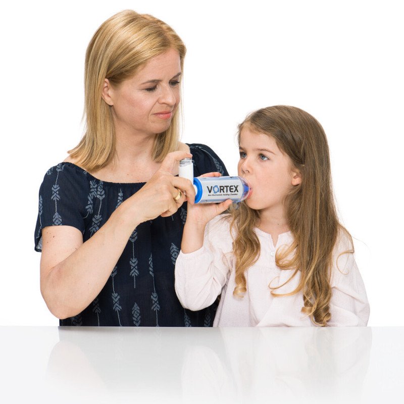 Asthma easy explanation for children: Holding chamber Mother helps daughter inhale asthma spray with a holding chamber