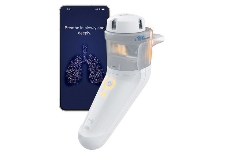 eFlow Integrated A white and gray PARI eFlow Integrated stands upright next to a smartphone displaying instructions to "Breathe in slowly and deeply" above a digital illustration of lungs.