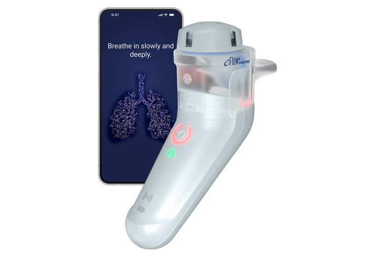 eFlow Integrated A white and gray PARI eFlow Integrated stands upright next to a smartphone displaying instructions to "Breathe in slowly and deeply" above a digital illustration of lungs.