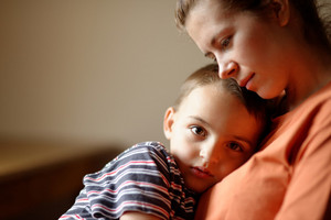 Child lies with head on mother’s chest