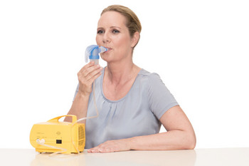 Woman inhales with inhaler