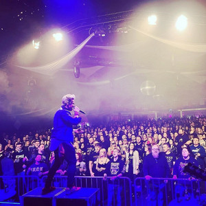 Singer on stage in front of cheering audience