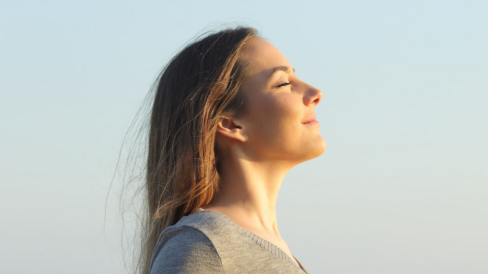 Woman from the side with closed lips breathing relaxed