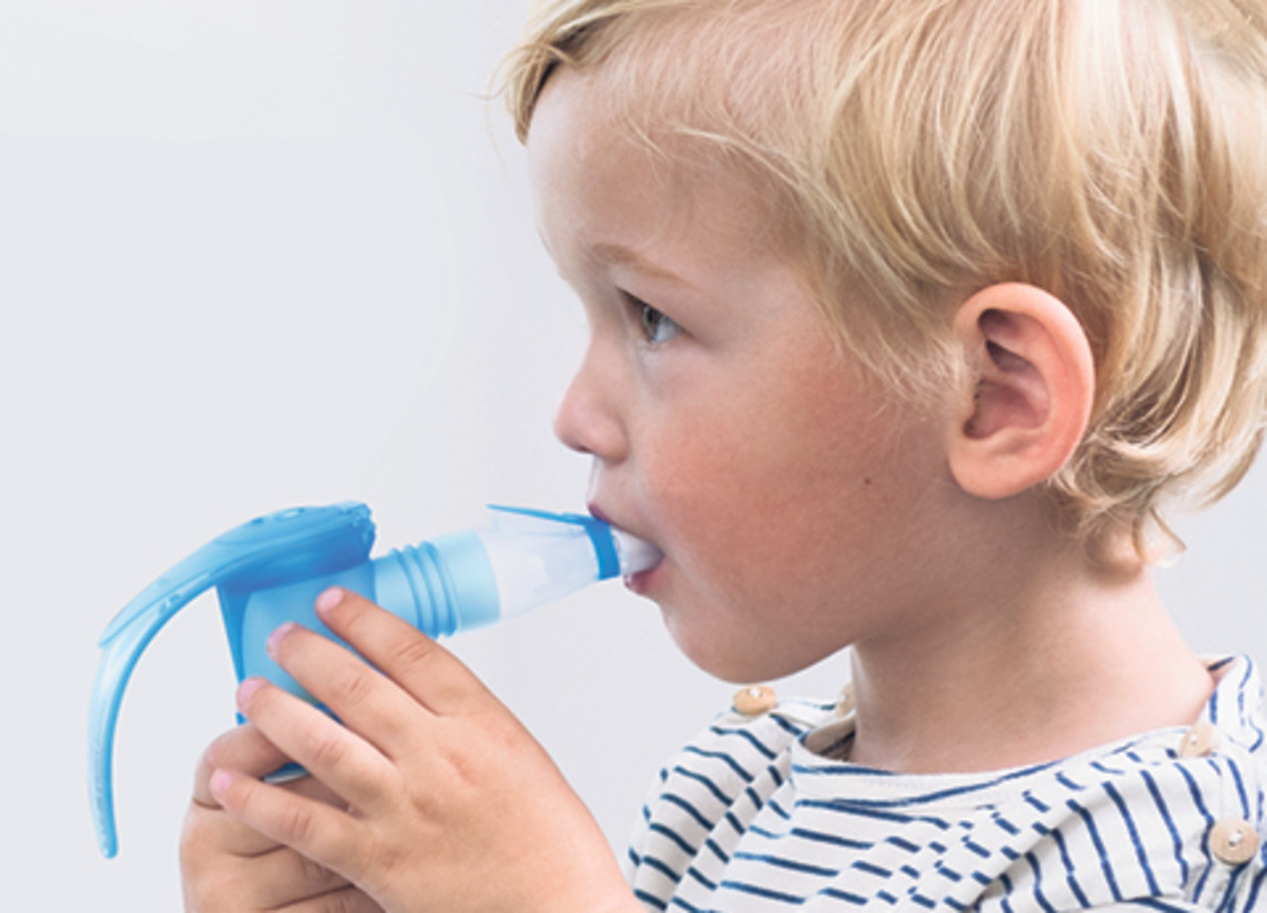 Young child using a nebulizer inhaler