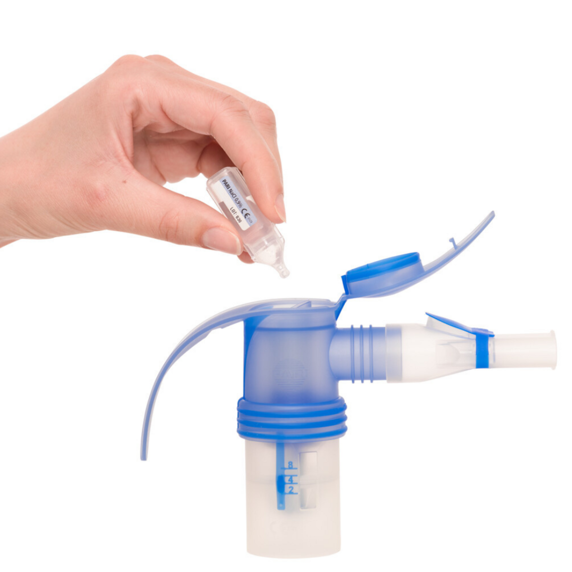 Home remedies against a cough: Saline solutions Close-up of a nebuliser a hand dripping inhalation solution into it
