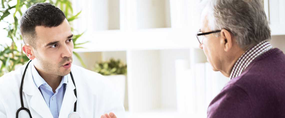 Healthcare professional speaking with an older person during a consultation