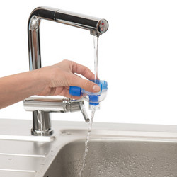 Mouthpiece of spacer is held by hand under running water tap