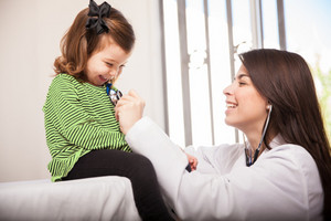 Little girl being examined by doctor