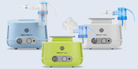 Drei PARI Inhalationsgeräte vor einem hellblauen Hintergrund. In der Mitte steht das grüne Modell, der PARI BOY Junior, links der blaue PARI COMPACT2 und rechts der weiße PARI BOY Classic. Alle Geräte sind mit einem PARI LC SPRINT Verneblern ausgestattet.