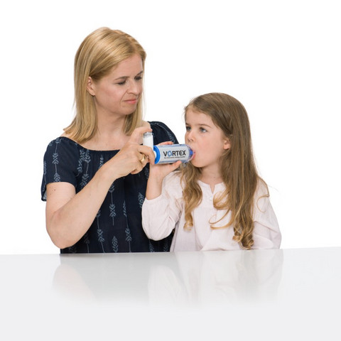 Mother help daughter using asthma spray