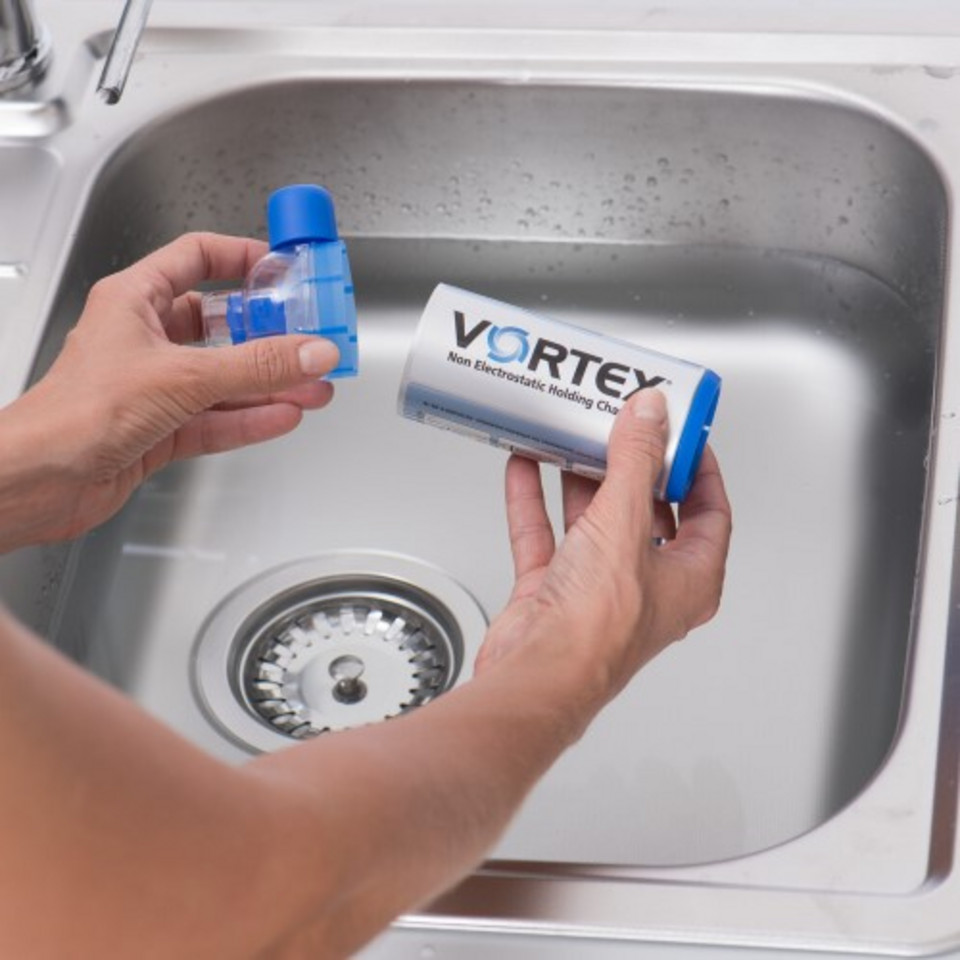 Hands hold spacer and mouthpiece above water