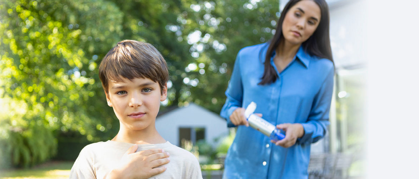 Child holds hand to chest while mother watches worriedly