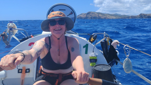 Young woman is rowing a boat