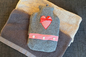 Hot water bottle lies on towel