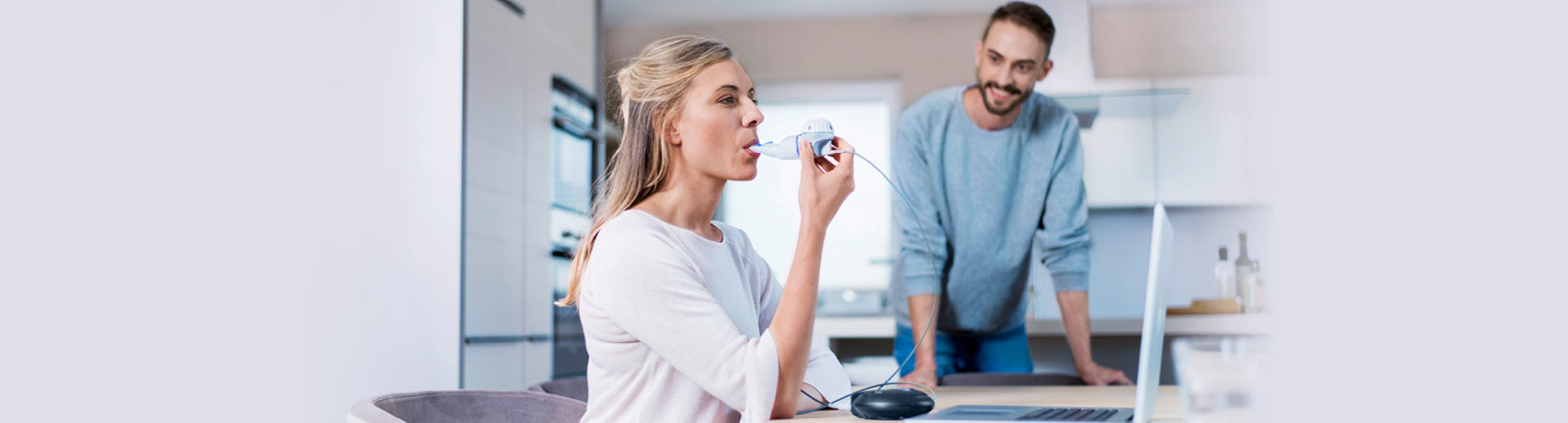 Woman inhales for treatment of cystic fibrosis