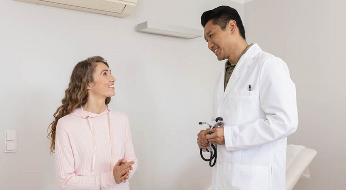 Healthcare professional discussing care with a person during a medical appointment