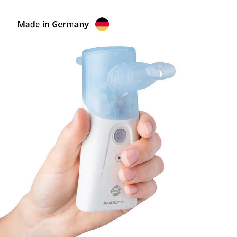 A hand is holding a portable PARI BOY Go inhaler with a mouthpiece; the words “Made in Germany” are visible in the image.