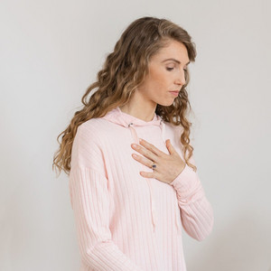 How to clear mucus from your lungs and airways: Autogenic Drainage Young woman breathes in deeply, one hand on her chest