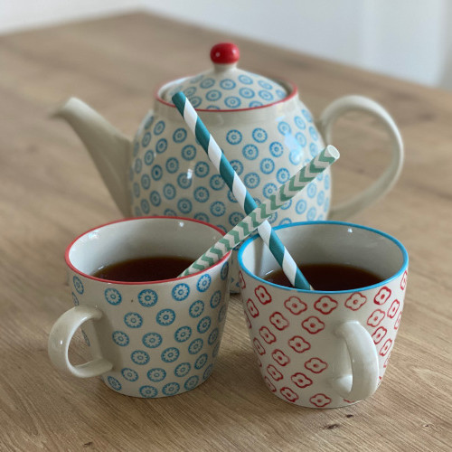 Jug and two cups with straws on the table