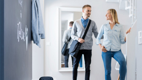 Man says goodbye to wife in hallway, inhalation device on bench