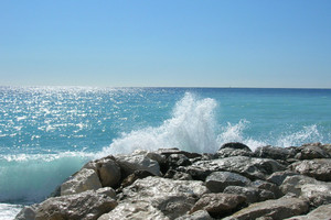 Wave breaks on rock