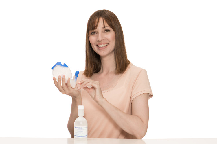 What you should do if you have a blocked nose because of an allergy: Nasal douche Young woman holds nasal douche and rinse into the camera