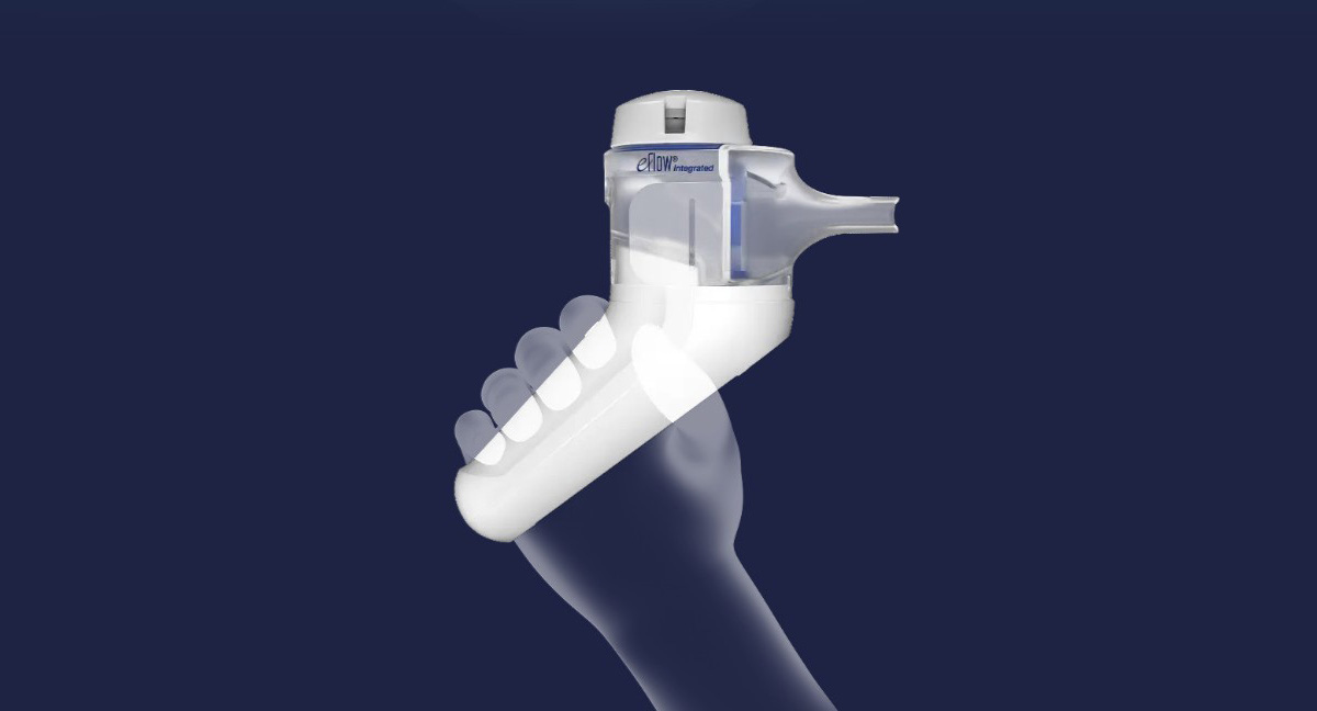 A hand holds a white and gray eFlow Integrated inhaler against a dark blue background.